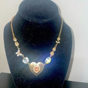 Gold toned necklace with iridescent jewel and diamond accent butterfly and roses